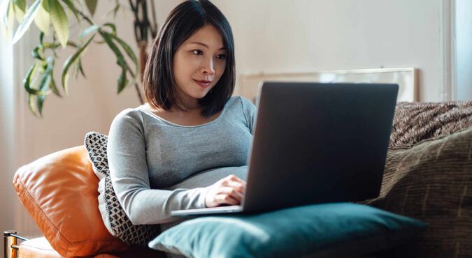 Mulher grávida mexendo no computador