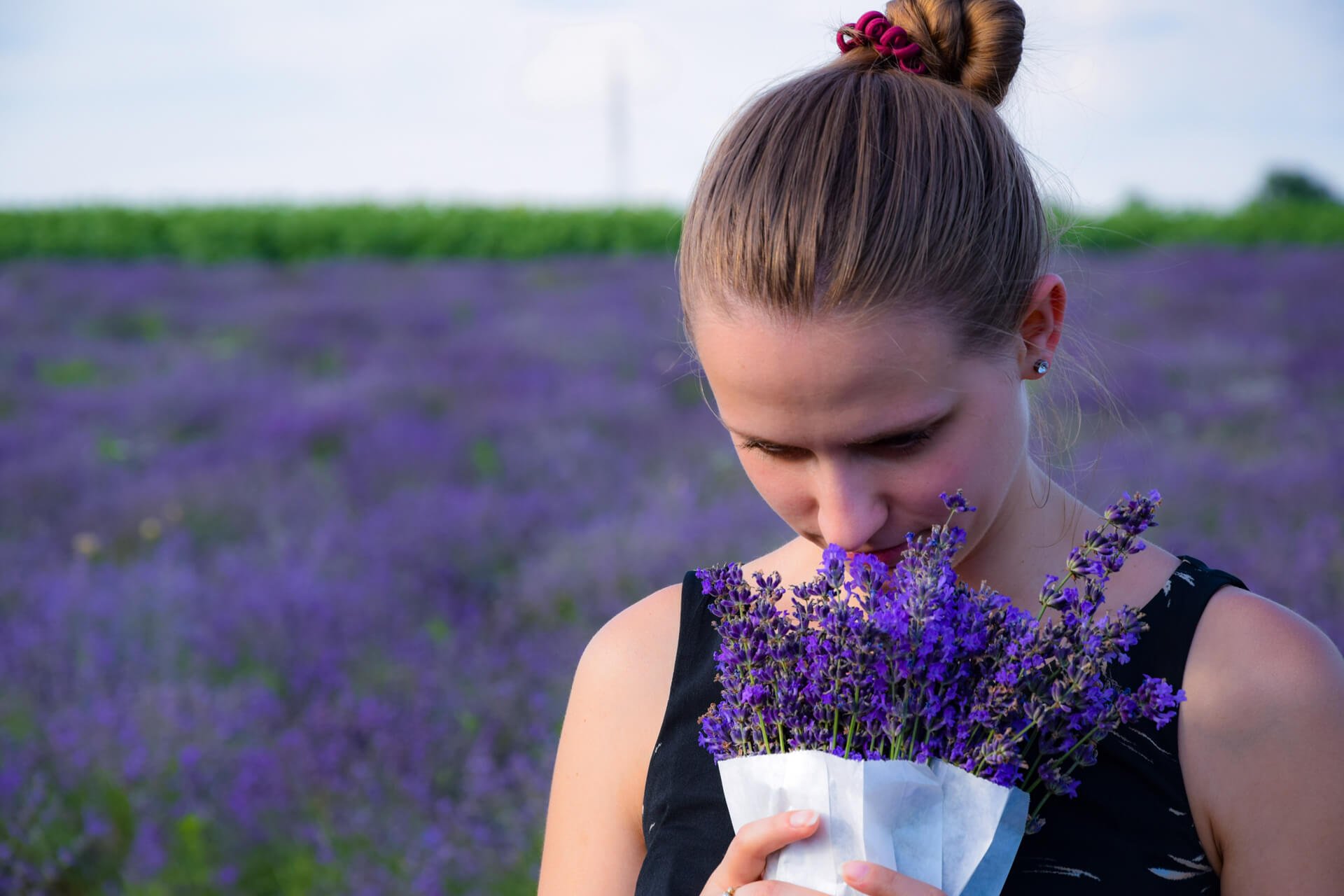 A person holding a flower Description automatically generated